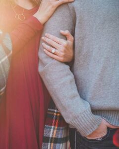 Close-up of an engaged couple embracing, highlighting the benefits with premarital counseling near me for a strong relationship.