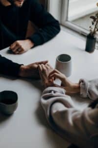 man and woman holding hands for best marriage counseling near Mt Pleasant