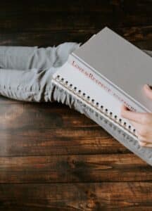 a woman holding book reading about marriage counseling online near me in Mount Pleasant, South Carolina