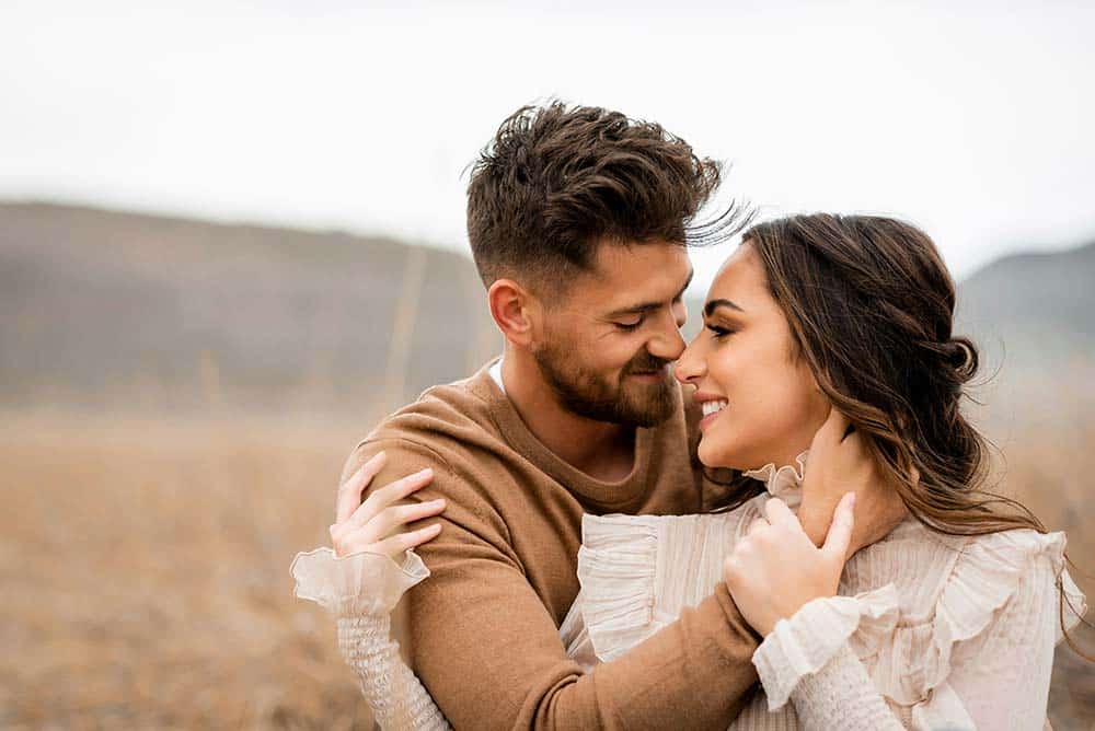 a-loving-couple-embraces-and-smiles-at-each-other