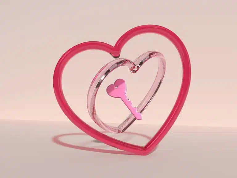 A Pink Heart Shaped Object with a Key Inside of It