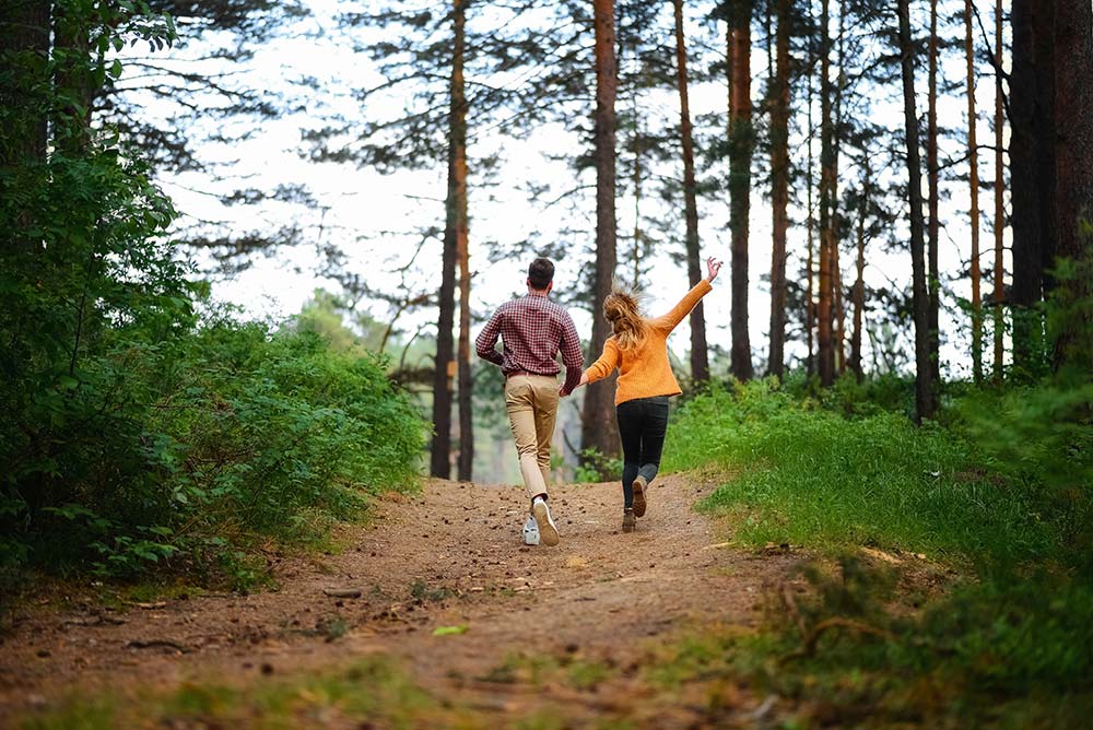 Man and Woman Walking on Forest