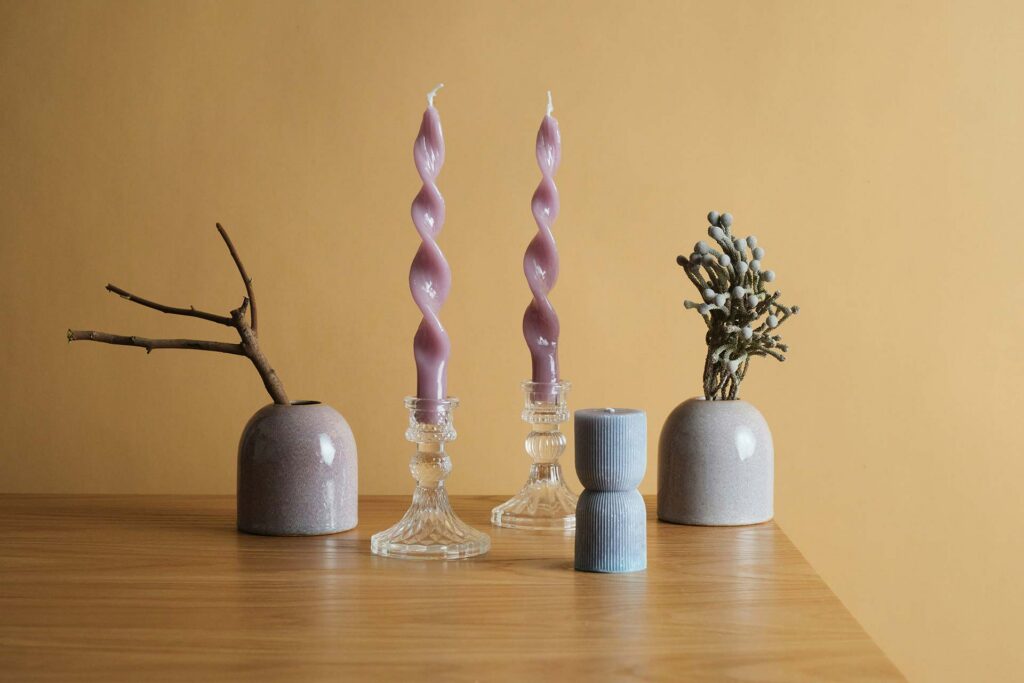 Wooden table topped with vases and candles