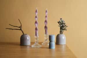 Wooden table topped with vases and candles