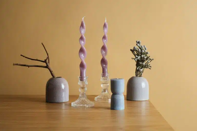 Wooden table topped with vases and candles