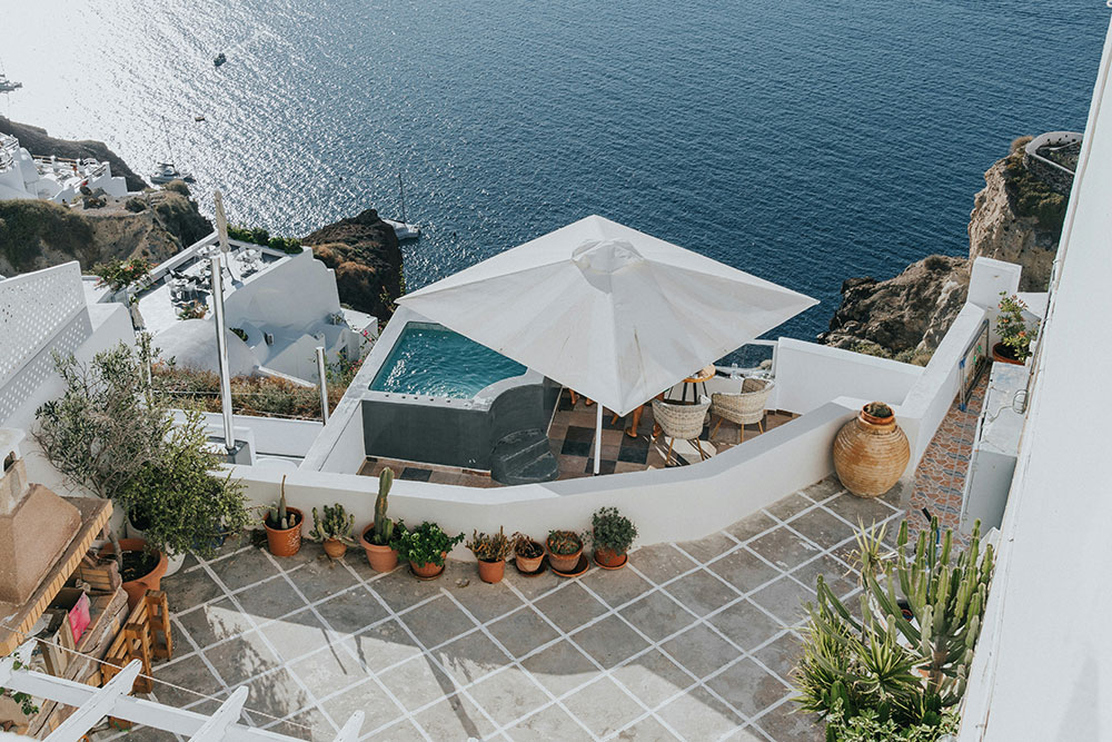 Aerial view of a house with a swimming pool and an umbrella